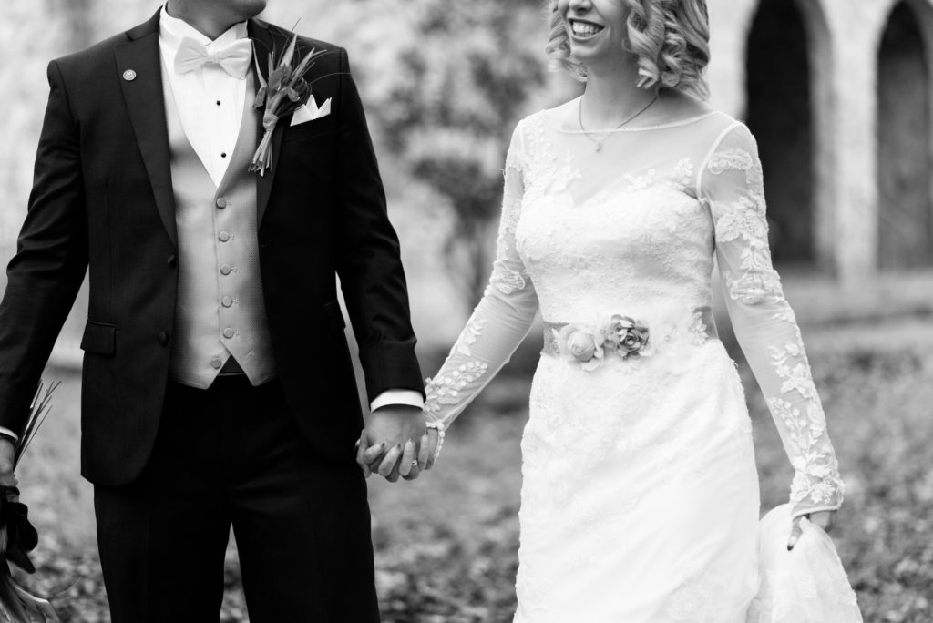 Bride and groom holding hands in black and white.
Photo by Black Tie & Co. www.btcweddings.com
