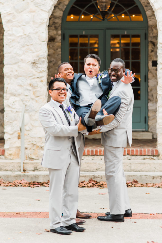 Groomsmen pick up groom for epic photo of them carrying him outside of the Alachua Woman's Club in Florida 
Photo by: Black Tie & Co. (www.btcweddings.com)
