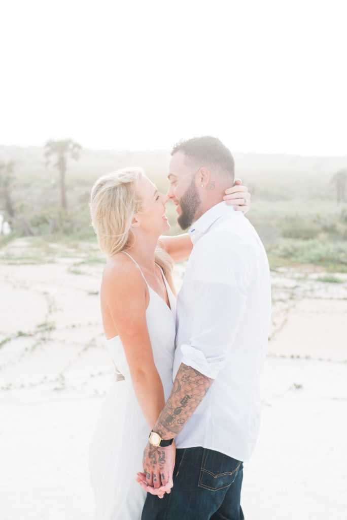 couple looking at each other as the sunsets engagement session palm coast florida beach
Photo by Chabeli Woolsey Black Tie & Co. www.btcweddings.com