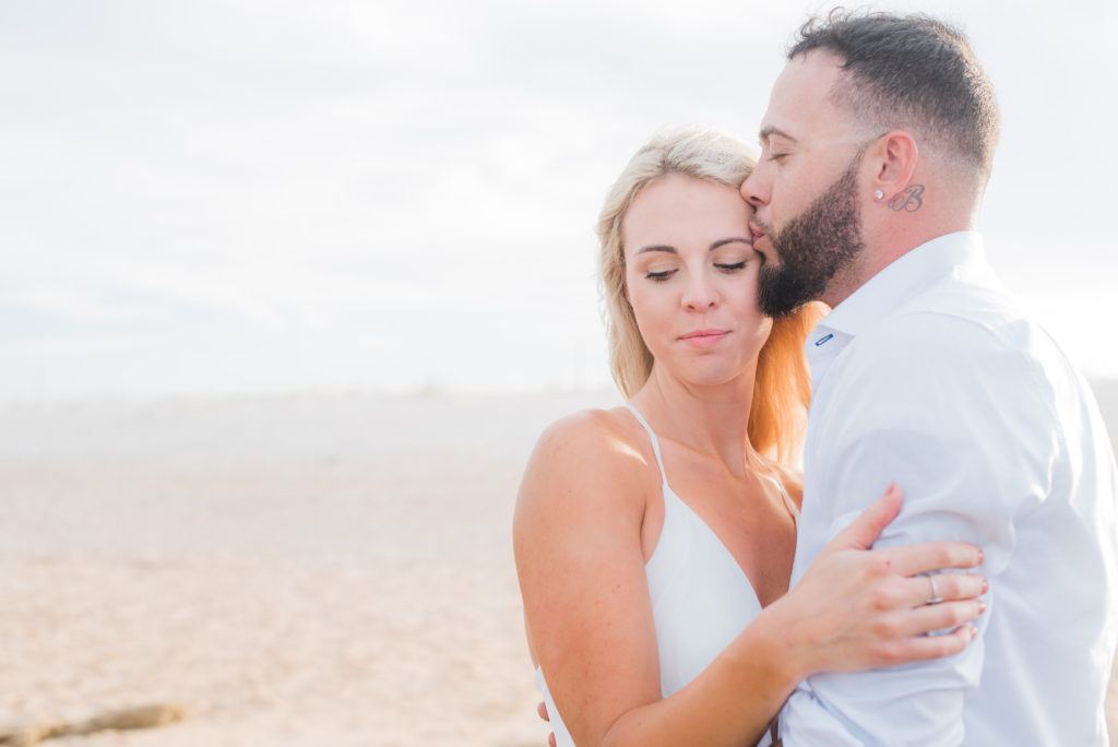 groom kissed bride's forehead during engagement photos sunset beach palm coast florida
Photo by Chabeli Woolsey Black Tie & Co. www.btcweddings.com