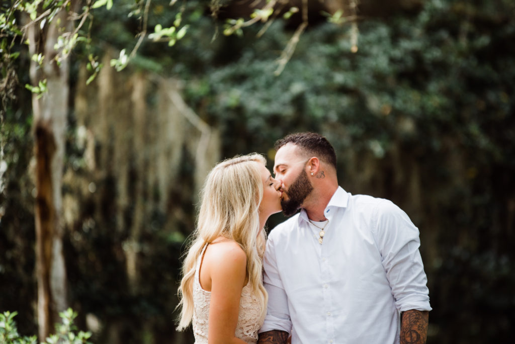 couple kisses in the gardens at washington oaks in palm coast 
photo by Chabeli Woolsey of Black Tie & Co www.btcweddings.com