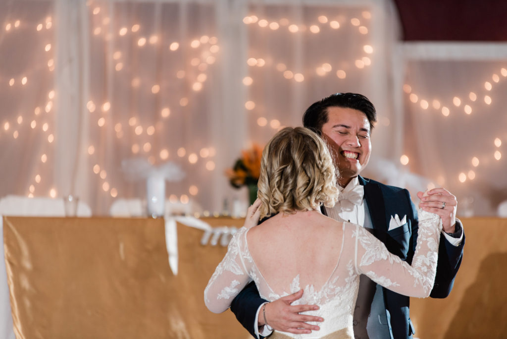 Groom smiling during the first dance 
Alachua Woman's Club in Florida 
Photo by: Black Tie & Co. (www.btcweddings.com)
