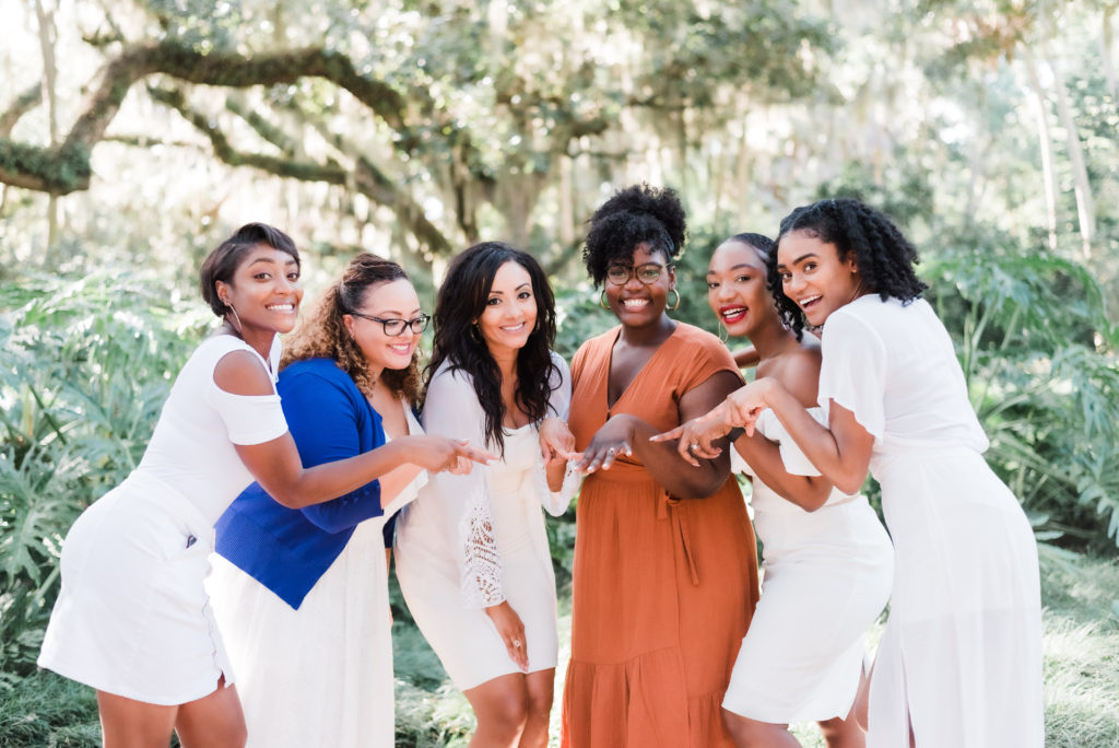 bride with her bridesmaids celebrating with family after the Washington Oaks Garden State Park surprise proposal Photo by Black Tie & Co. (www.btcweddings.com)